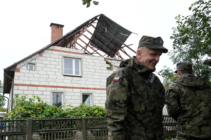 Territorial defense officers stand near a damaged house, after Russian drones violated Polish airspace during an attack on Ukraine, in Wyryki near Lublin, Poland, Sept 11,2025