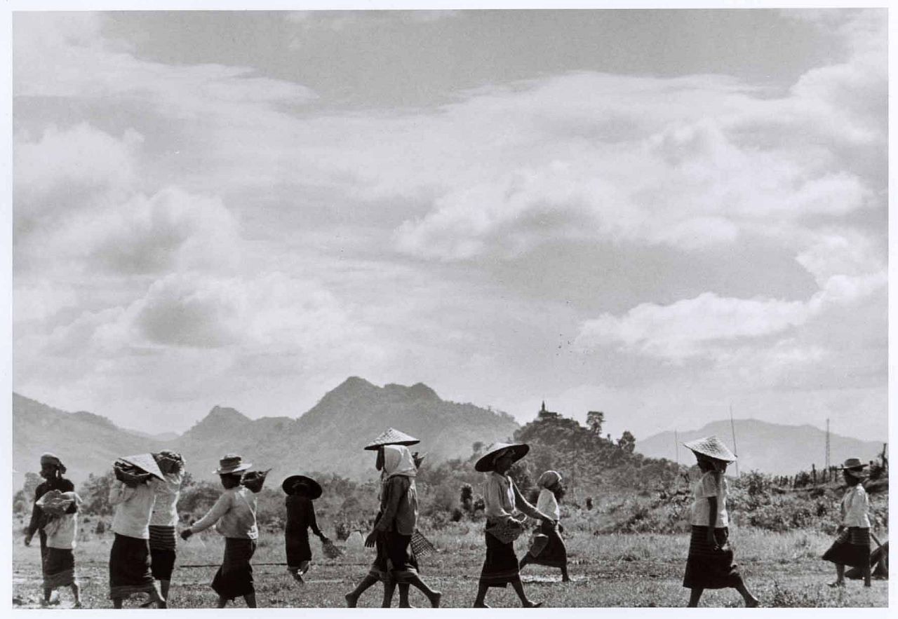 Women walking under midday sun, near Nam Định, Vietnam, May 1954