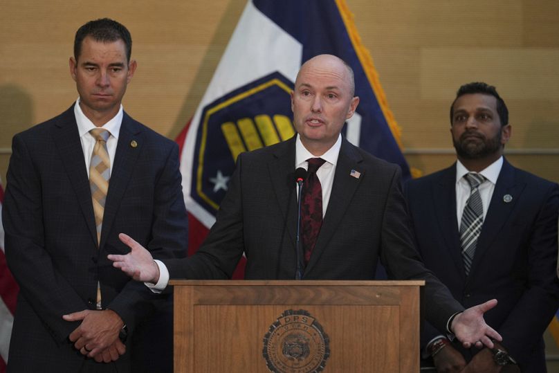 Utah Gov. Spencer Cox speaks at a conference, as department of public safety commissioner Beau Mason and FBI Director Kash Patel listens, Friday, Sept. 12, 2025, in Orem, Utah