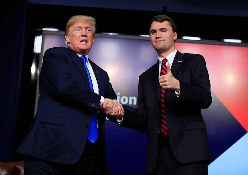 President Donald Trump shakes hands with moderator Charlie Kirk, during an event at the White House complex in Washington, Thursday, 22 March, 2018