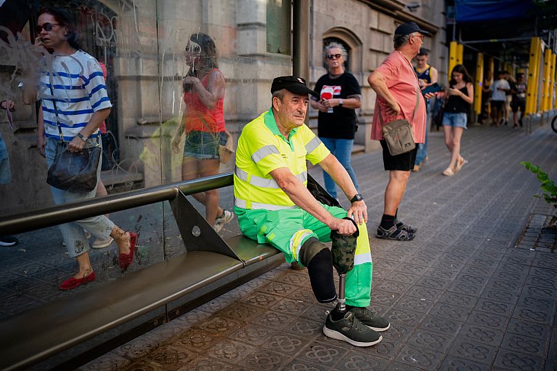 Street cleaner Raúl Rodriguez rests during a protest over the death of fellow cleaner during a recent heat wave in Barcelona, Spain.