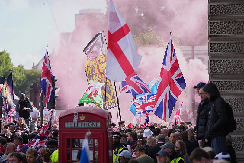 People demonstrate during the Tommy Robinson-led Unite the Kingdom march and rally in London, 13 September, 2025