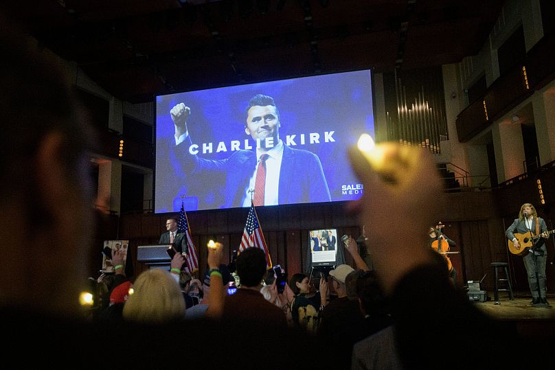 People hold candles and sing during a memorial and prayer vigil for Charlie Kirk at the John F. Kennedy Memorial Centre in Washington, 14 September, 2025