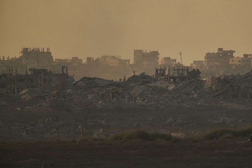 Buildings destroyed during the Israeli ground and air operations stand in the northern Gaza Strip during the sunset, as seen from southern Israel, Monday, Sept. 15, 2025.