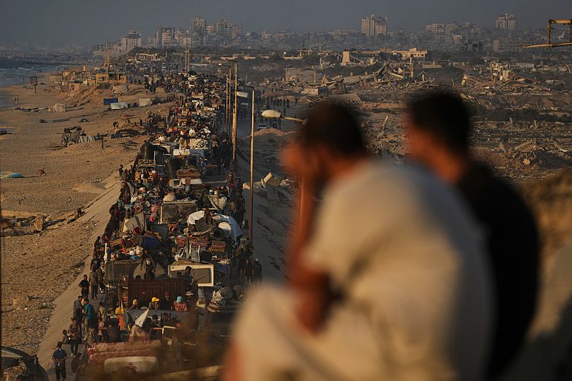 Displaced Palestinians flee northern Gaza by foot and in vehicles, carrying their belongings along the coastal road toward southern Gaza, Monday, Sept. 15, 2025. 