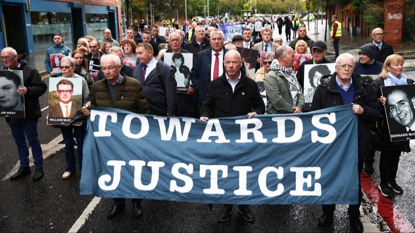 FILE: Families of the victims of the 1972 Bloody Sunday make their way to Belfast Crown court, Northern Ireland, Monday Sept. 15, 2025