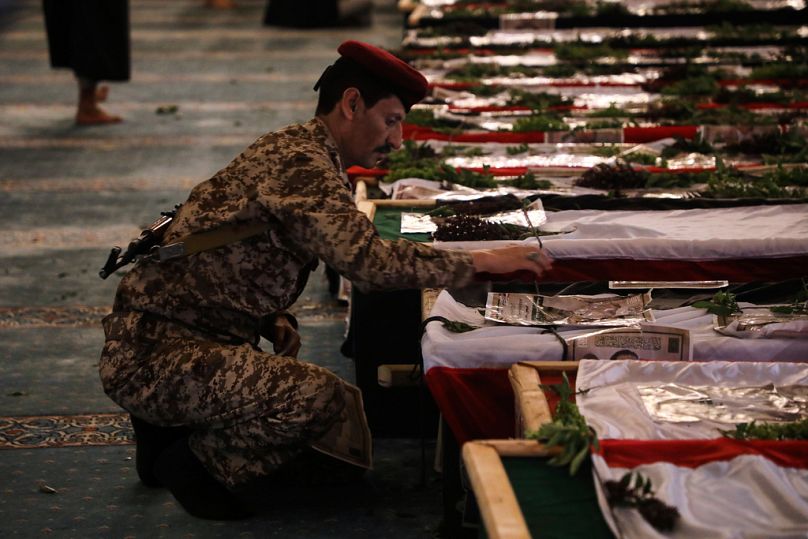 A Houthi officer mourns over a coffin of one of 31 local journalists reportedly killed in Israeli airstrikes last week, during their funeral in Sanaa, Yemen, Sept. 16, 2025