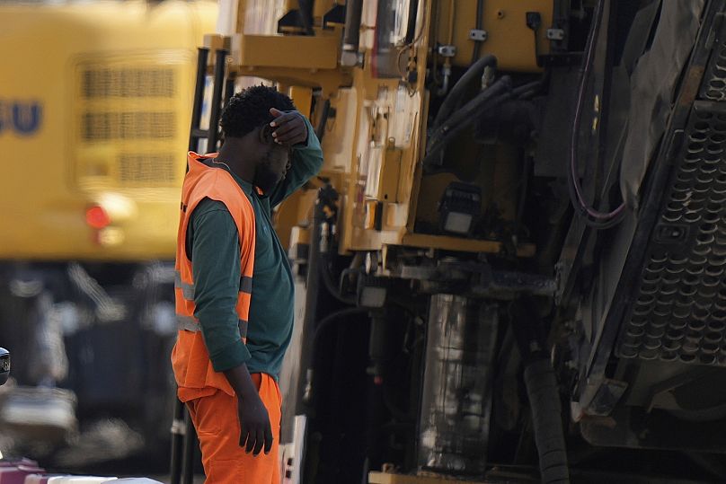 An employee takes a break as he works at a road construction site in Milan, Italy, July 1, 2025. 