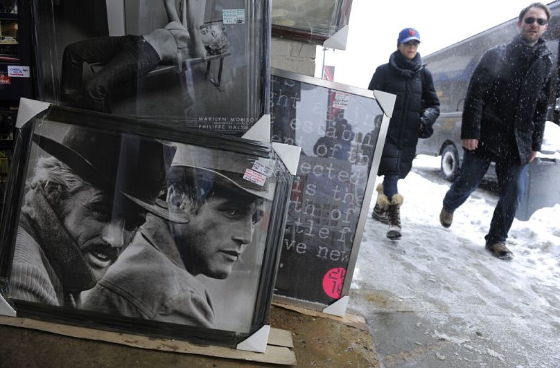 This Jan. 22, 2010, file photo, shows festivalgoers walking past a poster of Robert Redford, far left, and Paul Newman in the film "Butch Cassidy and the Sundance Kid" during 