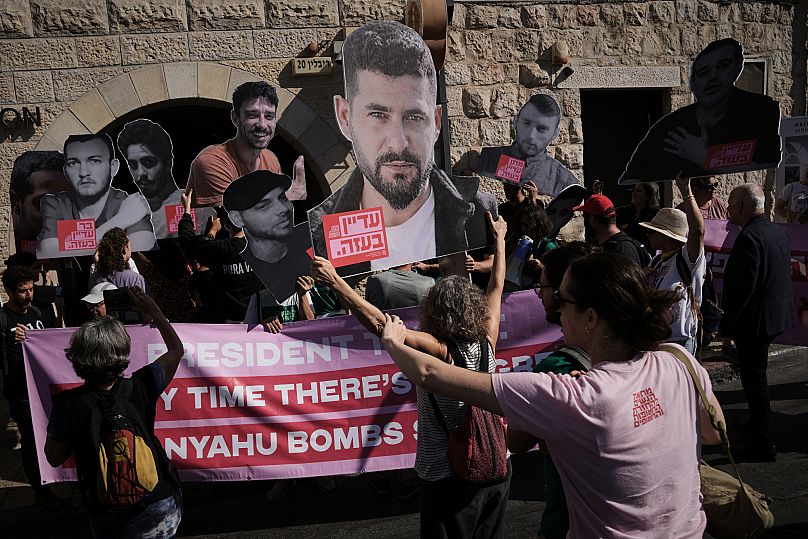 Demonstrators hold photos depicting the faces of Israeli hostages who are being held in Gaza during a protest in Jerusalem, 16 September, 2025