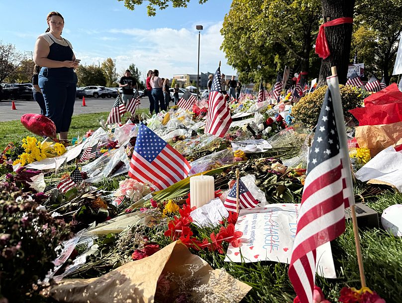 American flags and flowers are displayed at a memorial for Charlie Kirk at Utah Valley University in Orem, 15 September, 2025