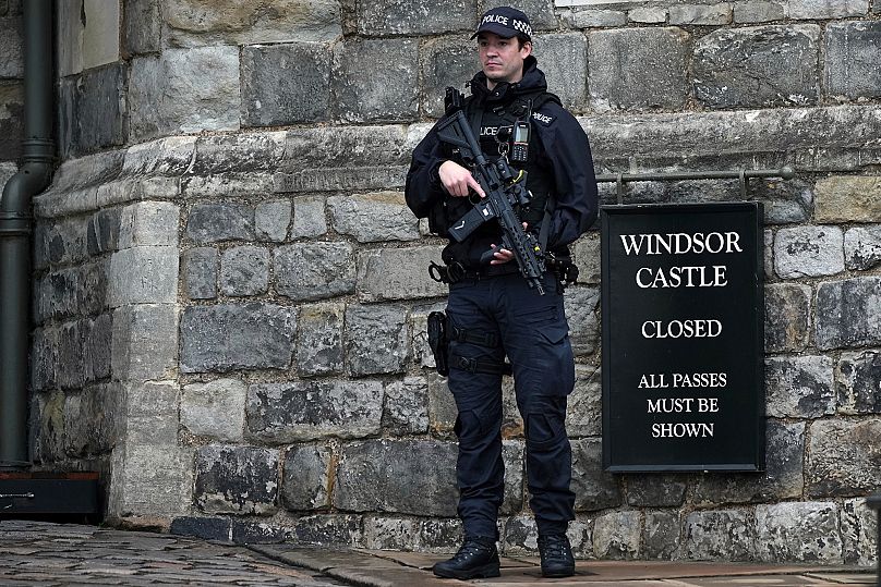 An armed police officer stands guard at the entrance to Windsor Castle ahead of the arrival of President Donald Trump in Windsor, 17 September, 2025