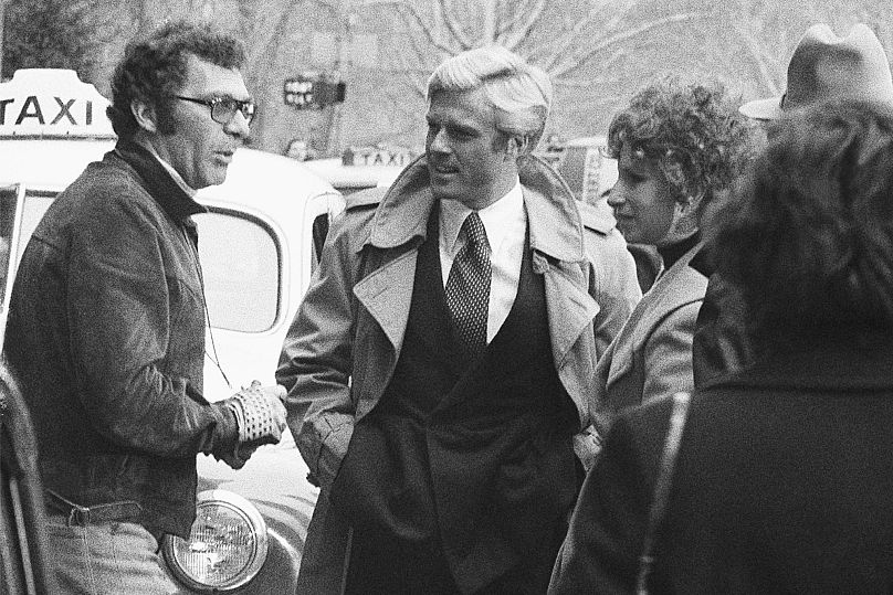 Director Sydney Pollack, left, appears with actors Robert Redford, center, and Barbra Streisand during the filming of 'The Way We Were' - New York, 1972