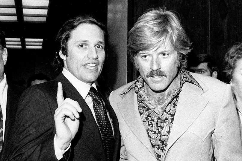 Washington Post reporter Bob Woodward, left, talks with actor Robert Redford following the premiere of 'All the President's Men' in Washington, on 5 April 1976