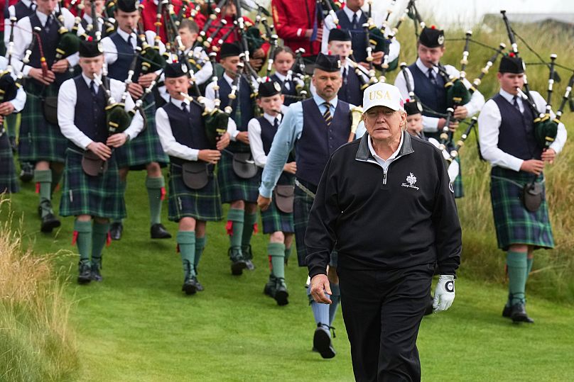Followed by a bagpiper band, US President Donald Trump arrives for the opening ceremony for his golf course in Scotland, July 29, 2025 (AP Photo/Jacquelyn Martin) 