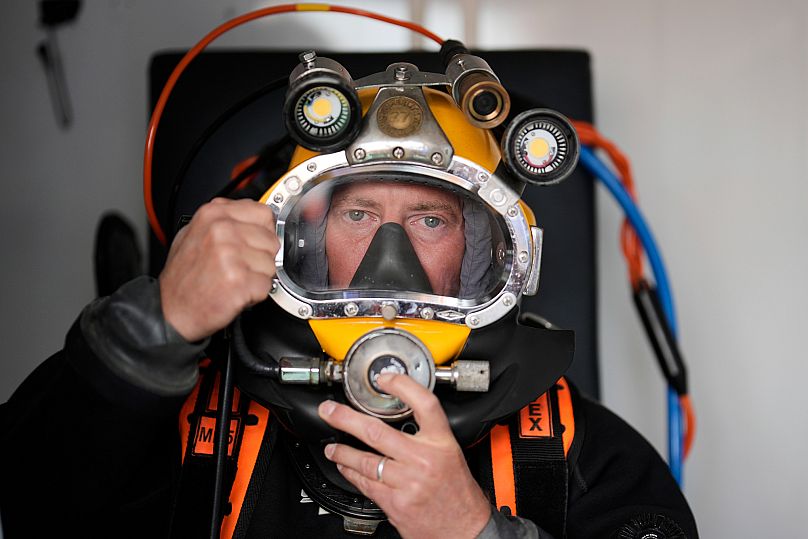  diver checks his equipment during a press tour to show the recovering of ammunition from World War II in the Baltic Sea near Boltenhagen, Germany.