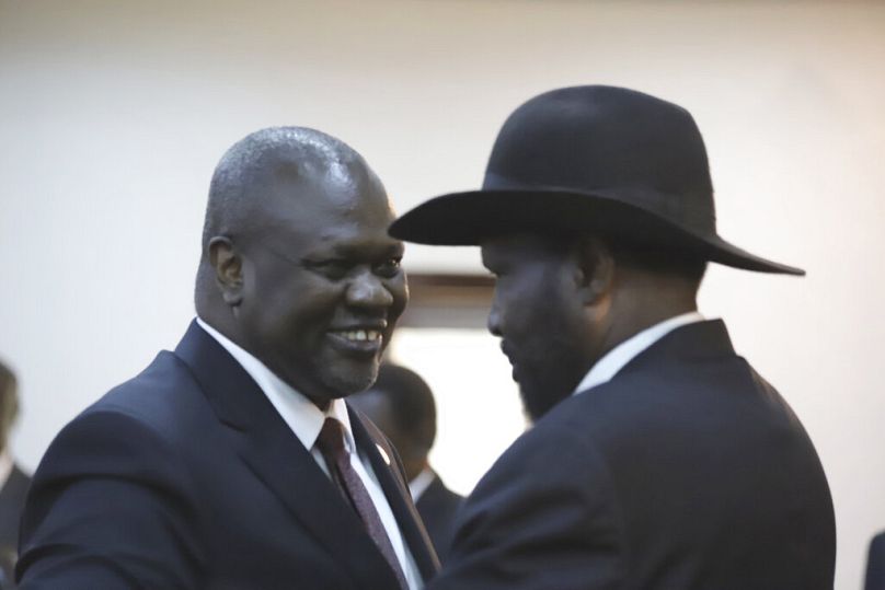 President Salva Kiir and Riek Machar (left) greet each other during the swearing-in ceremony of the president in 2020.