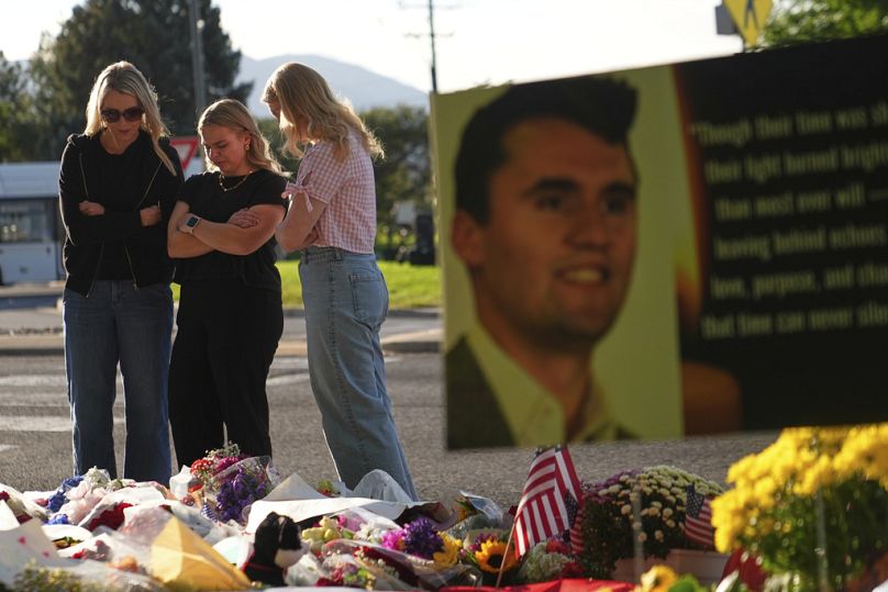 Women pray at a memorial outside Utah Valley University after Turning Point USA CEO and co-founder Charlie Kirk was shot and killed, Saturday, Sept. 13, 2025, in Orem, Utah. (