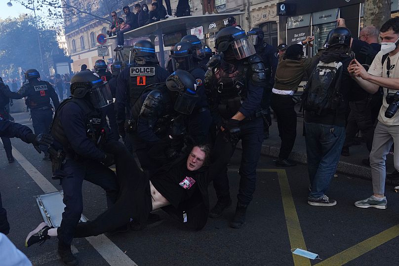 Police officers detain a protester during a demonstration called by major trade unions to oppose budget cuts in Paris, 18 September, 2025