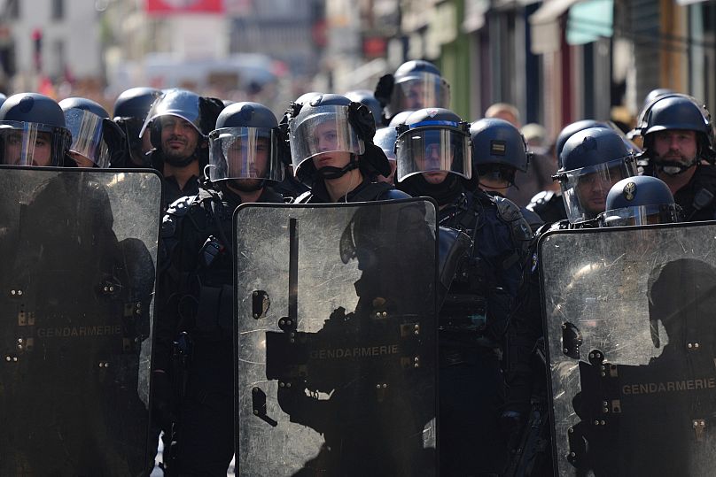 Police officers stand guard during a demonstration called by major trade unions to oppose budget cuts in Paris, 18 September, 2025