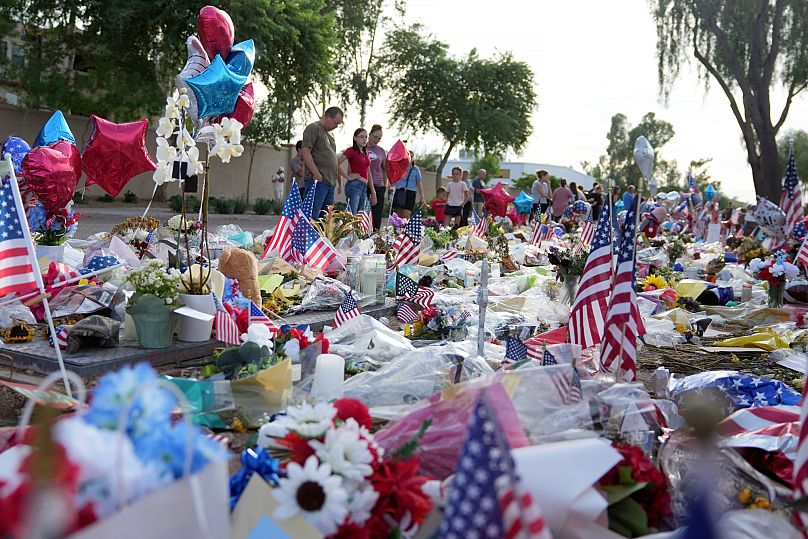 Mourners gather at a makeshift memorial to Charlie Kirk outside the Turning Point USA headquarters in Phoenix, Arizona, on 17 September, 2025.