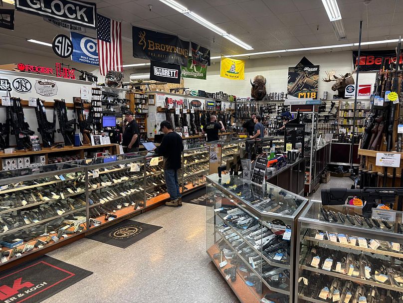 Customers line up at the till at the Gunnies gun store in Orem