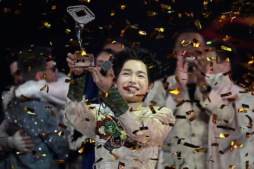 Vietnam's Duc Phuc celebrates with his trophy after winning the International Music Competition "Intervision" at the Live Arena outside Moscow, Russia