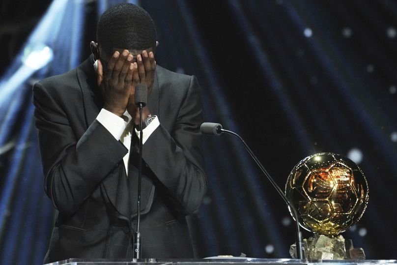 PSG's Ousmane Dembélé reacts as he receives the 2025 Men's Ballon d'Or during the 69th Ballon d'Or awards ceremony at the Theatre du Chatelet in Paris, Monday, Sept. 22, 2025