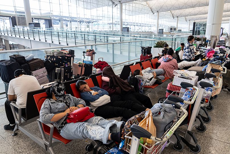 Passengers rest at the Hong Kong International Airport ahead of the Super Typhoon Ragasa approaching Hong Kong on 23 September.
