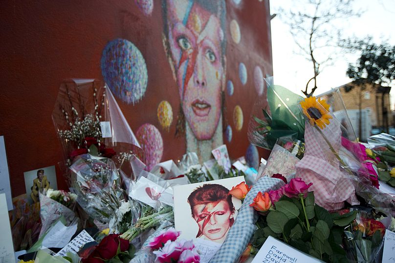 Tributes lie beside a mural of David Bowie - London, 12 January 2016