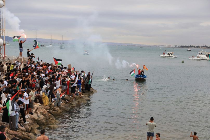 People gather to show support for the Global Sumud Flotilla ahead of its scheduled departure to deliver aid to Gaza amidst Israel's blockade in Tunis, Tunisia, Sept. 10, 2025.