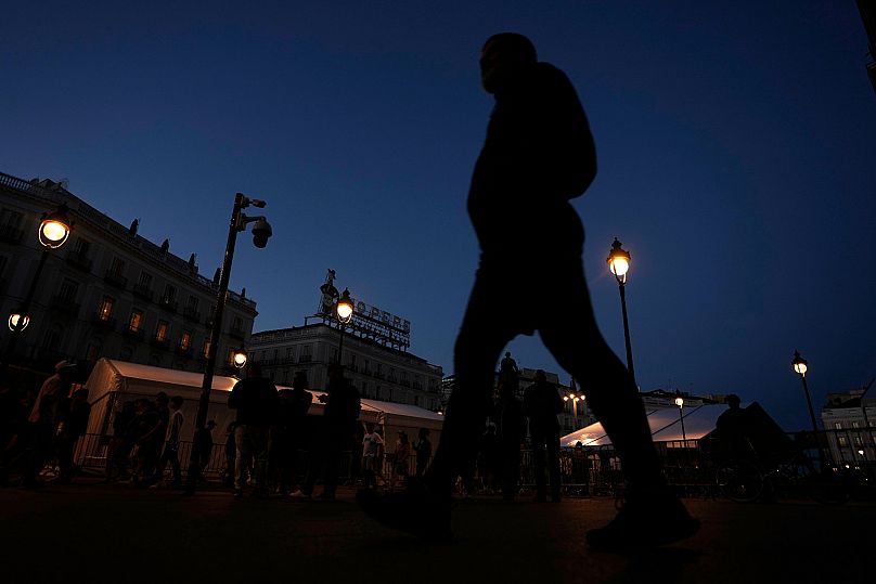 People walk in downtown Madrid during a major power outage, Monday, April 28, 2025