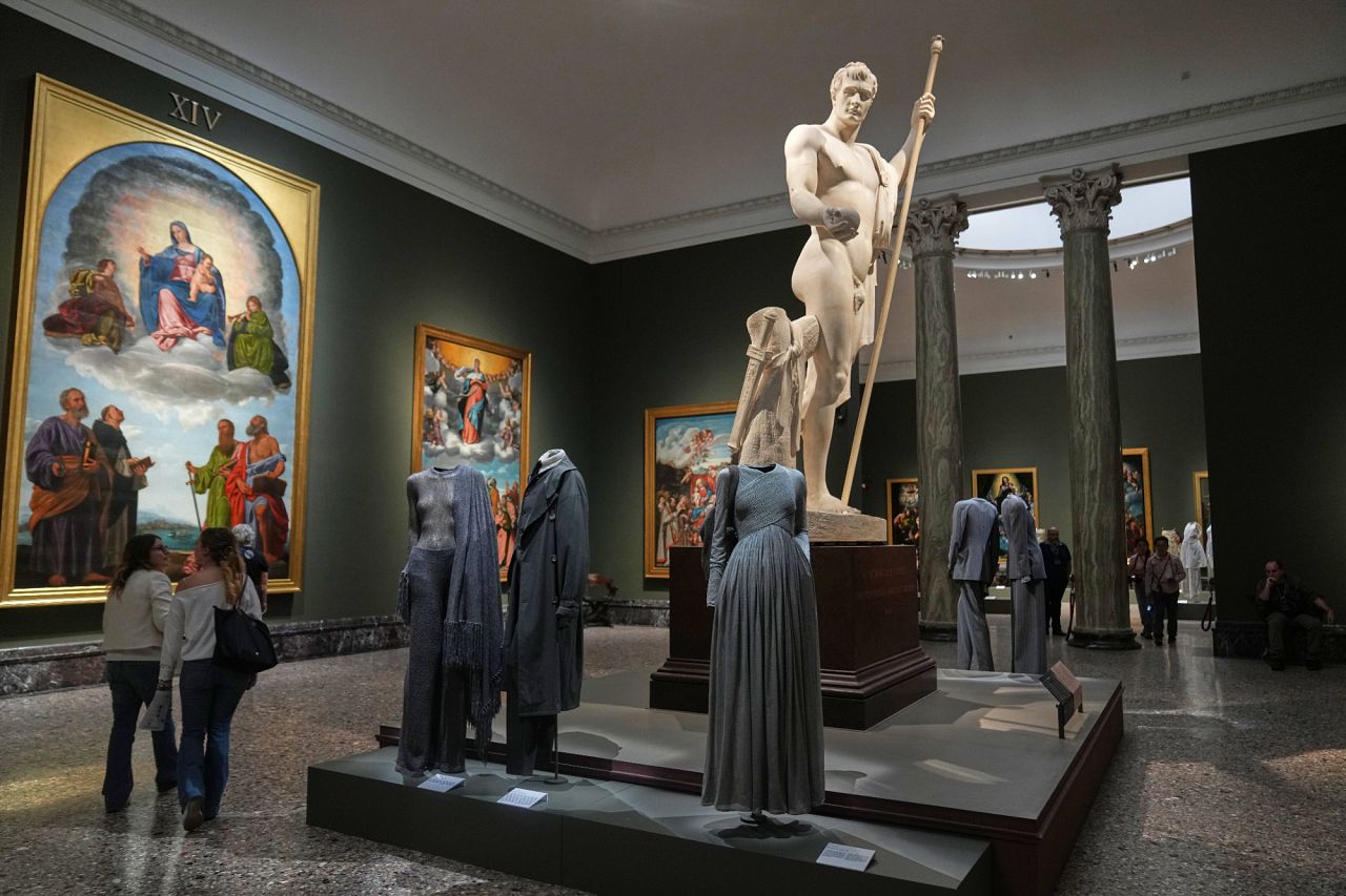 Statue of Napoleon I by Antonio Canova (1803-1806) looms over Giorgio Armani's creations on display during the exhibition “Giorgio Armani – 50 Years”