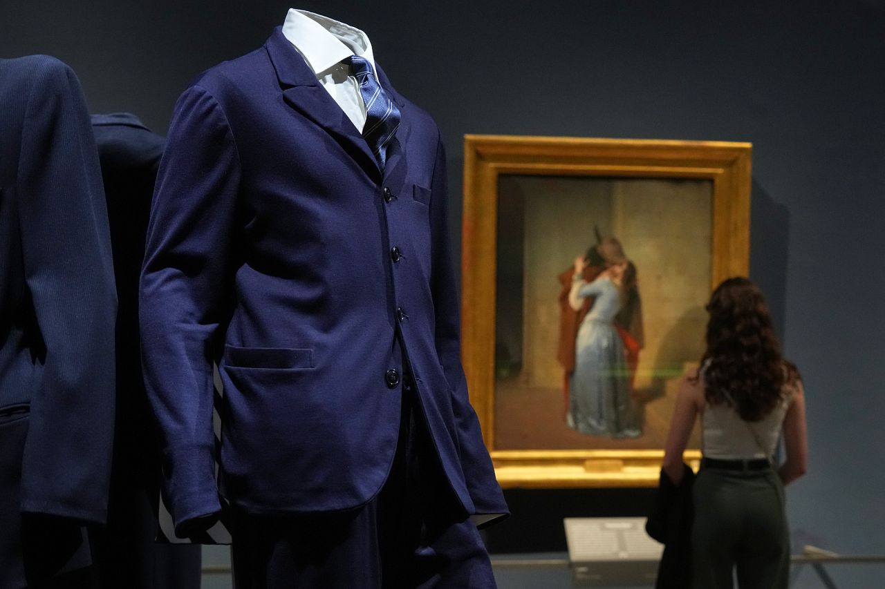 Giorgio Armani's creations are backdropped by the painting by Francesco Hayez titled "The Kiss"
