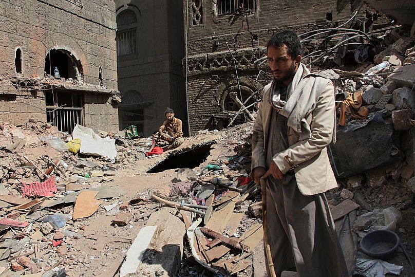 Two Yemeni men inspect the rubble of a house that was destroyed in Israeli air strikes in Sanaa, 13 September, 2025