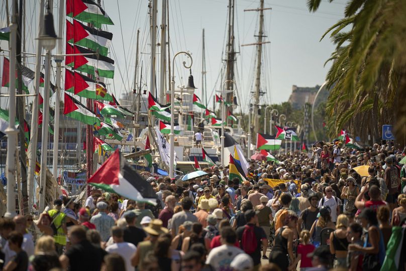 People crowd the dock ahead of the launch of the flotilla bound for Gaza, aiming to break Israel's blockade and deliver humanitarian aid in Barcelona, Spain, Aug. 31, 2025. 