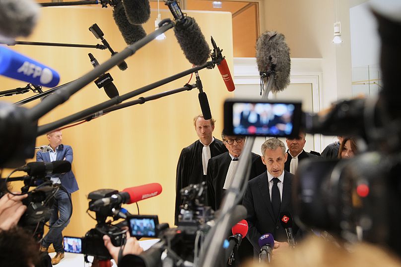 Former French President Nicolas Sarkozy speaks with the media after a Paris court sentenced him to five years in prison, 25 September, 2025 