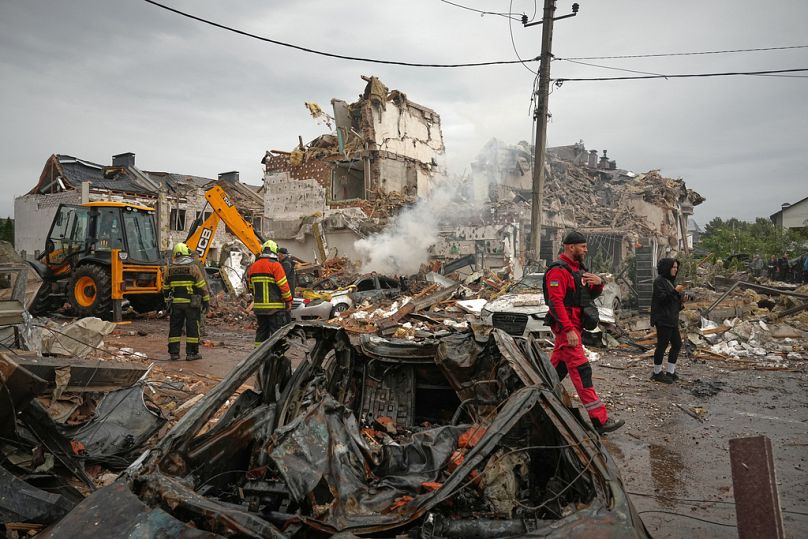 Rescuers work at the site of an apartment buildings damaged during a Russian attack in Kyiv, Ukraine, Sunday, Sept. 28, 2025