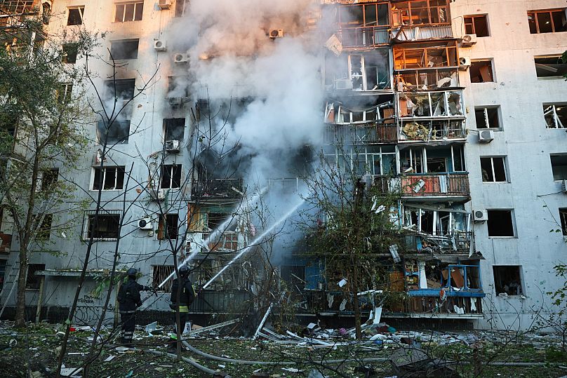 Rescue workers extinguish a fire of a house destroyed by a Russian strike in Zaporizhzhia, 28 September, 2025
