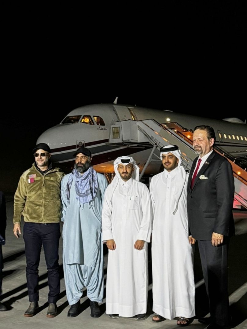 US citizen Amir Amiri, second from left, poses before boarding a plane in Kabul, Afghanistan, on Sunday, Sept. 28, 2025, after being released from an Afghan prison.