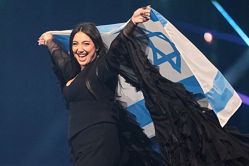 Singer Yuval Raphael from Israel holds the national flag during a dress rehearsal for the Grand Final of the 69th Eurovision Song Contest in Basel, 16 May, 2025