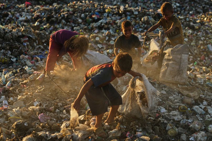 Displaced Palestinian children search for firewood and plastic in a landfill beside their tent camp where they are taking shelter, Khan Younis, Gaza, Tuesday, Sept. 30, 2025