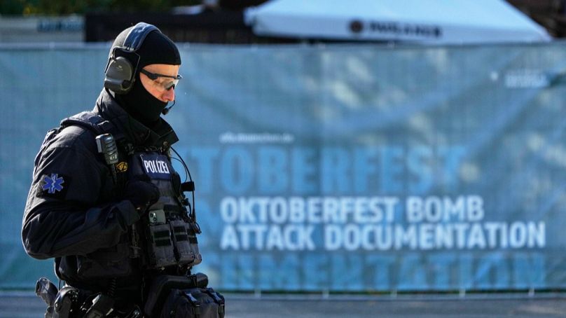 A police officer walks at the Oktoberfest area that stays closed after a bomb threatening in Munich, Germany, Wednesday, Oct.1, 2025