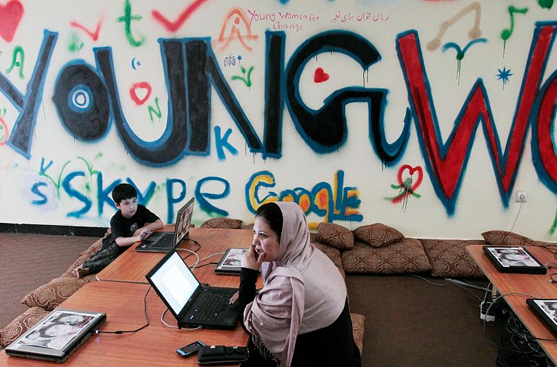 A woman sits in front of her computer at an Internet cafe in Kabul, 30 July, 2012