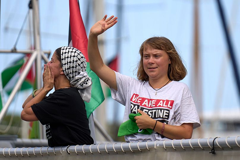 Swedish climate activist Greta Thunberg waves from a boat taking part in a civilian flotilla bound for Gaza in Barcelona, 31 August, 2025