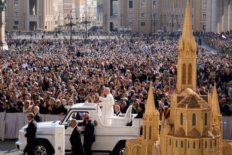 Pope Leo XIV waves as he arrives for his weekly general audience in St. Peter's Square at The Vatican, Wednesday, Oct.1, 2025