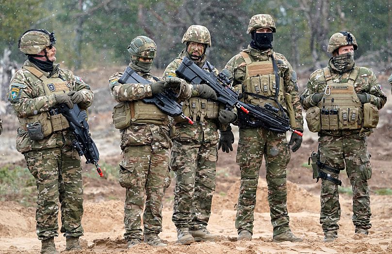 Slovenian troops stand during military exercises in Adazi Military base in Kadaga, 8 March, 2022
