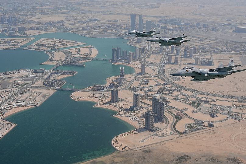 Qatar Emiri Air Force F-15s provide an honorary escort for Air Force One, carrying President Donald Trump, as it arrives in Doha, 14 May, 2025