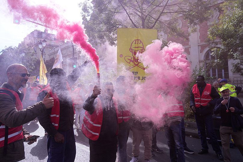 Unionists use flares during a new round of strikes and protests against the caretaker government and cost-cutting in Paris, 2 October, 2025 