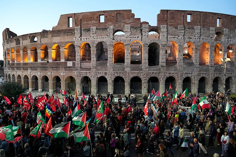Pro-Palestinian demonstrators gather in front of the Colosseum in Rome, Thursday, Oct. 2, 2025.